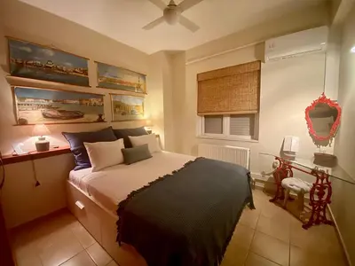 a bedroom with a bed and a desk and a window at Atreas’ Art Studio in Chania Town