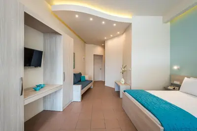 a hotel room with a bed and a couch at Studios Rika in Plataniás