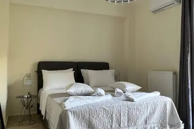 a bedroom with a bed with two towels on it at Anna Kavros luxury apartment in Chania Town