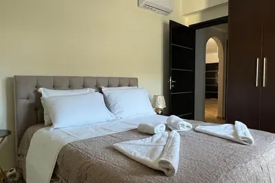 a bedroom with a bed with towels on it at Anna Kavros luxury apartment in Chania Town