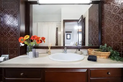 a bathroom with a sink and a large mirror at Casa Bella Vista in Kalathas