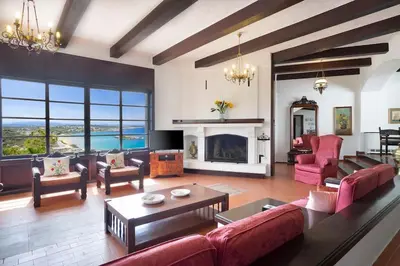 a living room with a couch and a fireplace at Casa Bella Vista in Kalathas