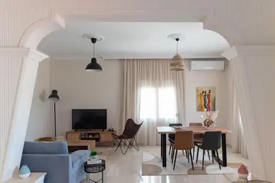 a living room with a blue couch and a table at Katofli Slow Living in Pithárion