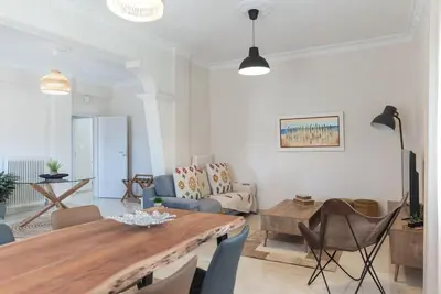 a living room with a large wooden table and chairs at Katofli Slow Living in Pithárion