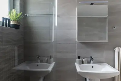 a bathroom with a sink and a mirror at Katofli Slow Living in Pithárion