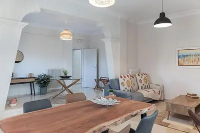 a living room with a table and a couch at Katofli Slow Living in Pithárion
