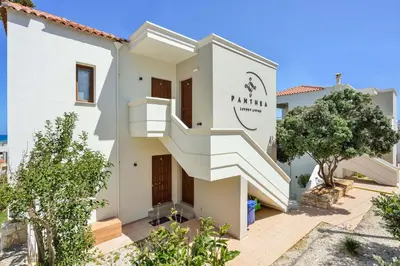 a white house with stairs in front of it at Panthea Luxury Living in Kolymvari