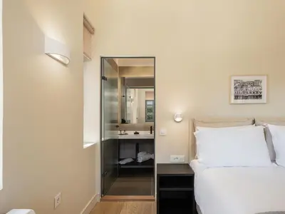 a bedroom with a mirror next to a bed at La Torre del Kastelli in Chania Town