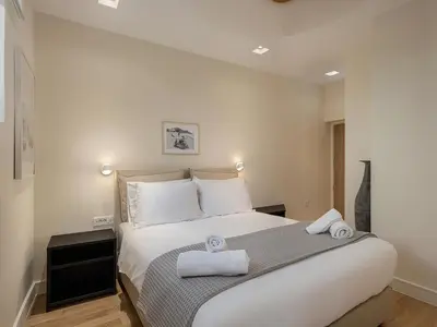 a bedroom with a large bed with towels on it at La Torre del Kastelli in Chania Town