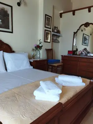 a bedroom with a bed with two towels on it at Porta di Sabbia in Koum Kapi beach in Chania Town