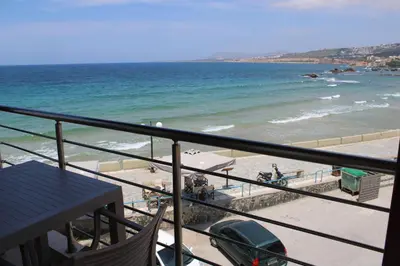 a balcony with a view of a beach and the ocean at Porta di Sabbia in Koum Kapi beach in Chania Town