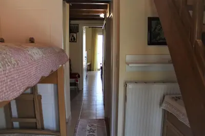 a hallway leading to a bedroom with a bed and a staircase at Porta di Sabbia in Koum Kapi beach in Chania Town