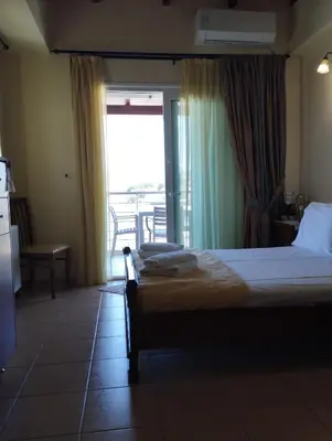 a bedroom with a bed and a view of a balcony at Porta di Sabbia in Koum Kapi beach in Chania Town