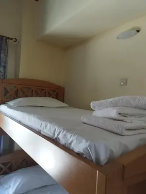 a bed with white sheets and towels on it at Porta di Sabbia in Koum Kapi beach in Chania Town