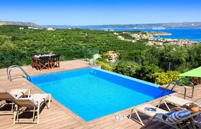 a villa with a swimming pool and a view at Villa Asteriskos in Áyios Andhréas