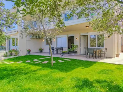 a house with a yard with green grass at Renovated apartment 3- Platanias in Plataniás