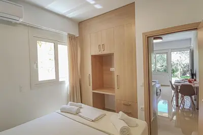 a bedroom with a bed and a desk and a window at Renovated apartment 3- Platanias in Plataniás