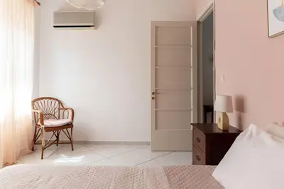a bedroom with a bed and a chair and a table at Casa Valore central with parking by 8essentially in Chania Town