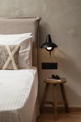 a lamp on a table next to a bed at Nomas lifestyle living in Chania Town