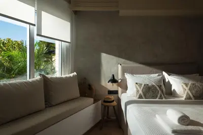 a bedroom with a bed and a window and a couch at Nomas lifestyle living in Chania Town