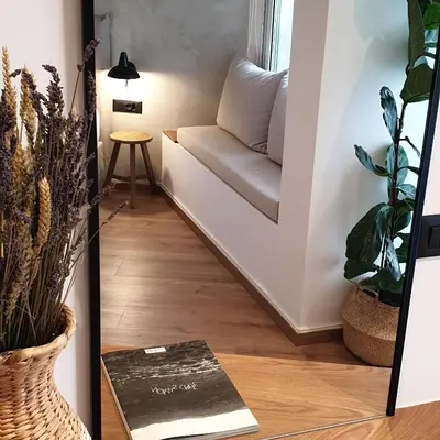 a stairway with a couch in a room with plants at Nomas lifestyle living in Chania Town