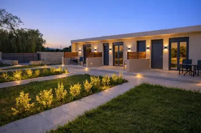 a house with a garden at night with lights at Sweven boutique apartments in Souda