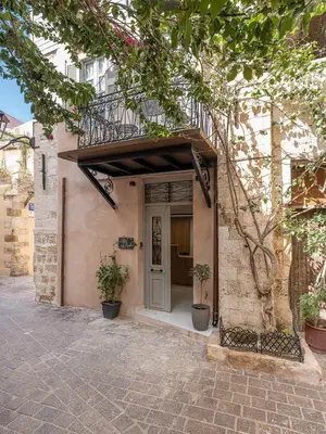 a building with a door and a balcony at Porto Vecchio in Chania Town