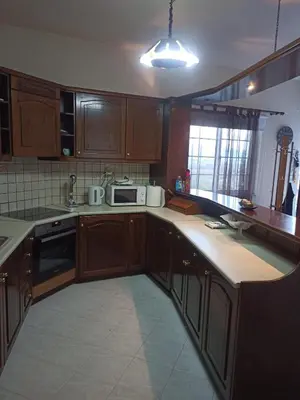 a kitchen with wooden cabinets and a counter top at Giannis House in Kissamos in Kissamos