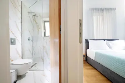 a bedroom with a bed and a bathroom with a toilet at Casa Verde Chania in Chania Town