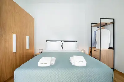 a bedroom with a bed with two white towels on it at Casa Verde Chania in Chania Town