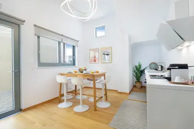 a kitchen with a table and chairs in a room at Casa Verde Chania in Chania Town