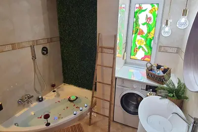 a bathroom with a tub and a washing machine at E&G Relax Homes-C in Kissamos