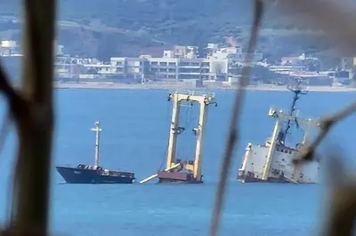 two cranes sitting in the water with a boat at E&G Relax Homes-C in Kissamos
