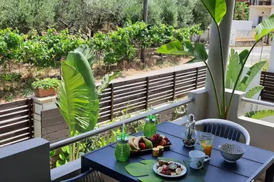 a blue table with a bowl of fruit on a balcony at E&G Relax Homes-C in Kissamos