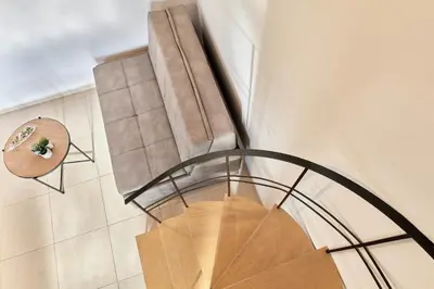 a spiral staircase in a building with a circular stair case at serenissimo A&A in Galatás