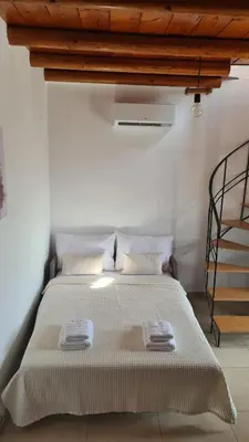 a bedroom with a bed with two towels on it at serenissimo A&A in Galatás