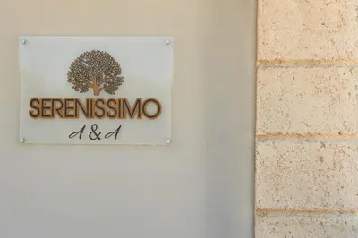a sign on a wall with a tree on it at serenissimo A&A in Galatás
