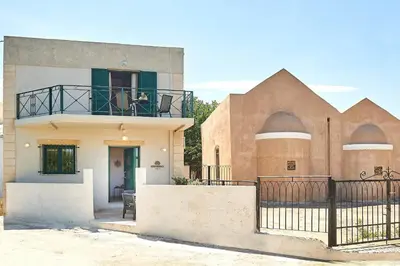 a house with a balcony on top of it at serenissimo A&A in Galatás