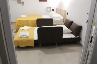 a small room with two beds and a couch at Angel's Nest in Chania Town
