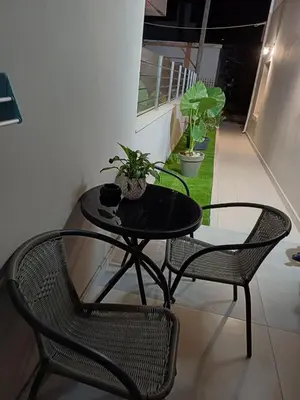 a black table with two chairs and a table with plants on it at Angel's Nest in Chania Town
