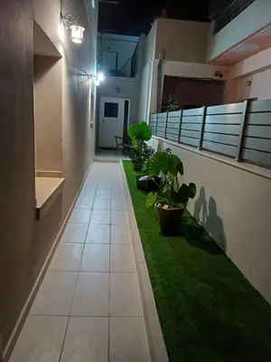 a hallway with green grass and plants in a building at Angel's Nest in Chania Town