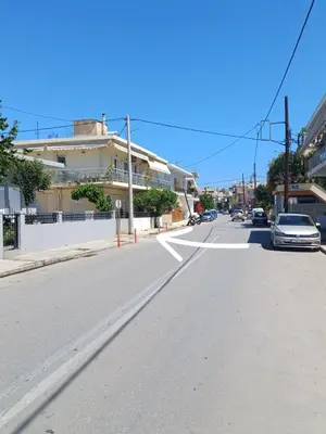 an empty street with a car driving down the street at Angel's Nest in Chania Town