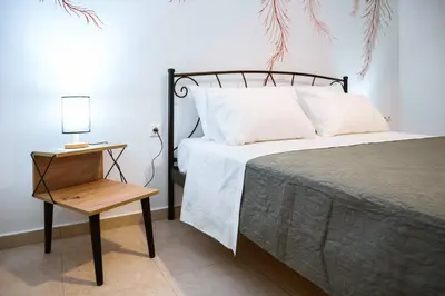 a bedroom with a bed and a night stand with a lamp at Nikola's Vineyard in Ayiá