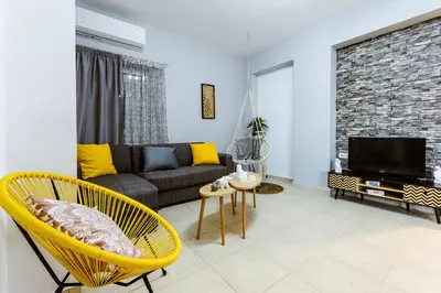 a living room with a couch and a tv at Nikola's Vineyard in Ayiá
