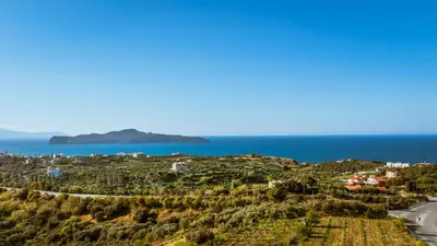a view of a mountain with the ocean in the background at Nikola's Vineyard in Ayiá