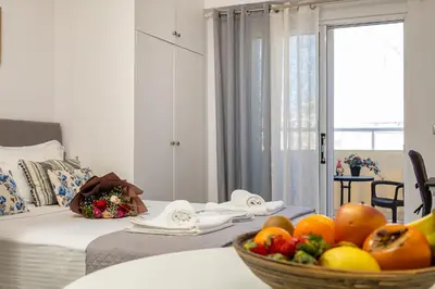 a room with a bed and a bowl of fruit on a table at Koum Kapi Mare Studios B2 in Chania Town