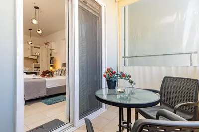 a room with a table and chairs and a bedroom at Koum Kapi Mare Studios B2 in Chania Town