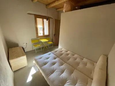 a living room with a white couch and yellow chairs at Petres old village house in Áyios Ioánnis