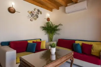 a living room with a couch with colorful pillows at Garden Villa Chania in Chania Town