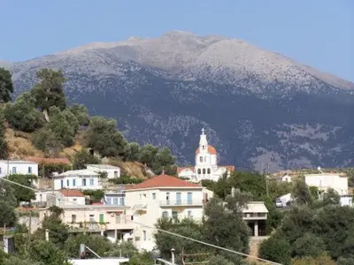 a town on a hill with a mountain in the background at VILLA APHRODITE SOUGIA apt1 in Kamária
